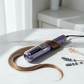Purple electric split end hair trimmer on marble surface with lavender and hair clip